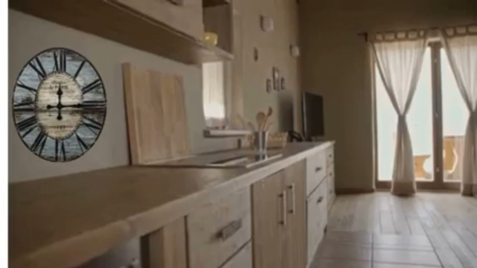Design Like A Pro. Full Kitchen With An Old wooden Cock On The Wall