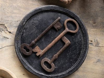 Vintage iron locks with skeleton keys displayed on a farmhouse table