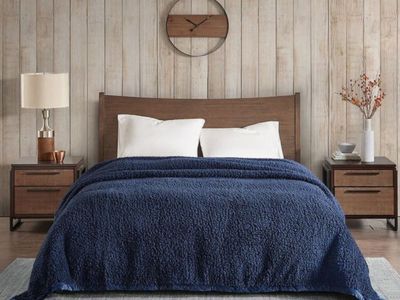 Navy farmhouse bed blanket displayed in a simple country bedroom