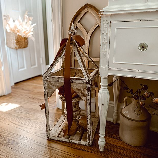 Rustic church-shaped lantern displayed in a vintage farmhouse room