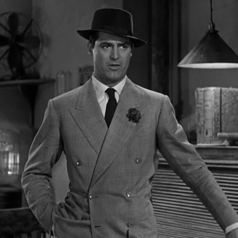 Cary Grant wearing a classic fedora and double-breasted suit in His Girl Friday (1940)